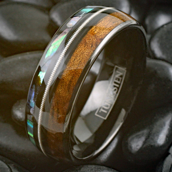 Cool Polished Black Tungsten Low Dome Ring with Silver Guitar String Between Iridescent Abalone And Whiskey Barrel Oak Wood Inlays.