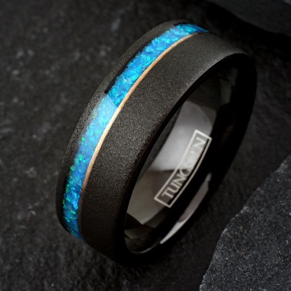 Elegant Brushed Finish Black Flat Band Tungsten Ring with Off-Center Asymmetrical Man-Made Teal Blue Opal Inlay And Rose Gold Stripe.