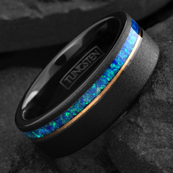 Elegant Brushed Finish Black Flat Band Tungsten Ring with Off-Center Asymmetrical Man-Made Teal Blue Opal Inlay And Rose Gold Stripe.
