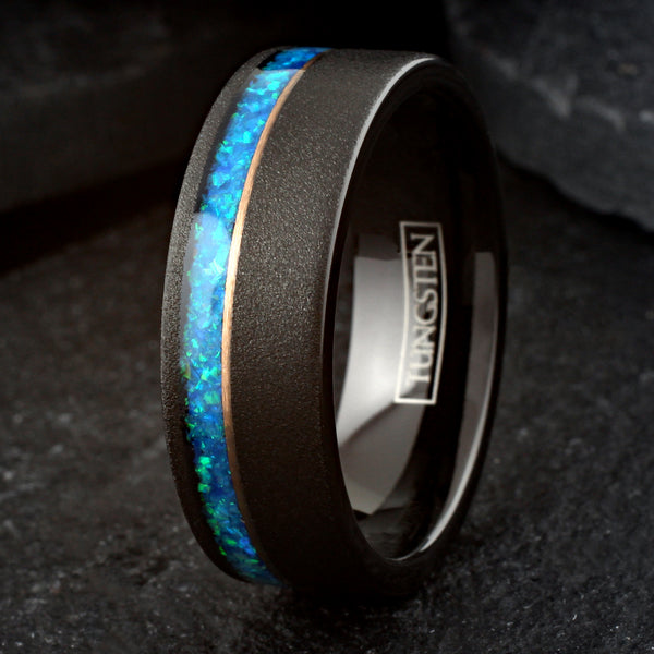 Elegant Brushed Finish Black Flat Band Tungsten Ring with Off-Center Asymmetrical Man-Made Teal Blue Opal Inlay And Rose Gold Stripe.
