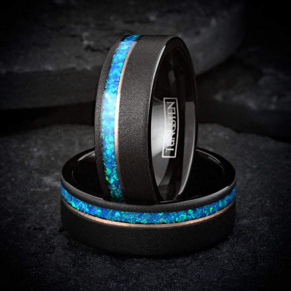 Elegant Brushed Finish Black Flat Band Tungsten Ring with Off-Center Asymmetrical Man-Made Teal Blue Opal Inlay And Rose Gold Stripe.