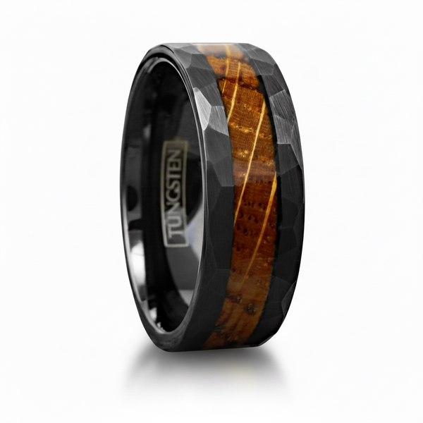 A faceted black tungsten ring with a natural brown wood inlay