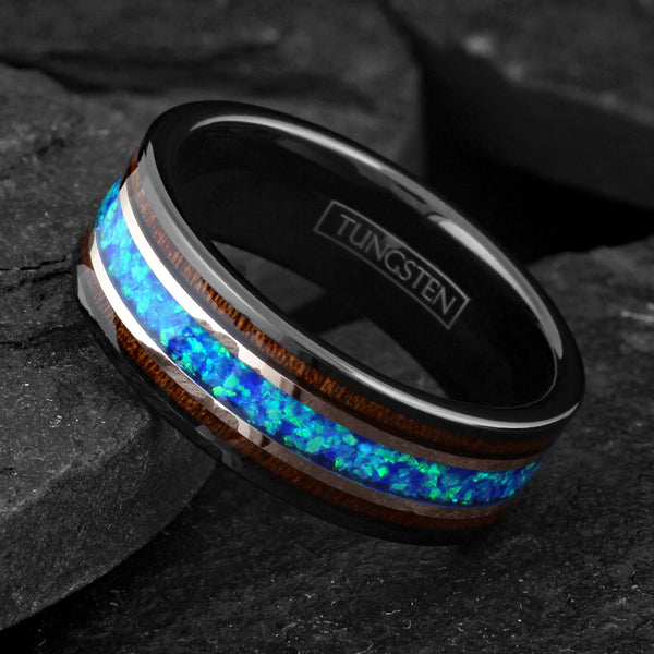 Beautiful Polished Black Tungsten Flat Band Ring with Iridescent Man-Made Crushed Hawaii Blue Opal Inlay Between Two Rose Bands Surrounded By Koa Wood Inlays.