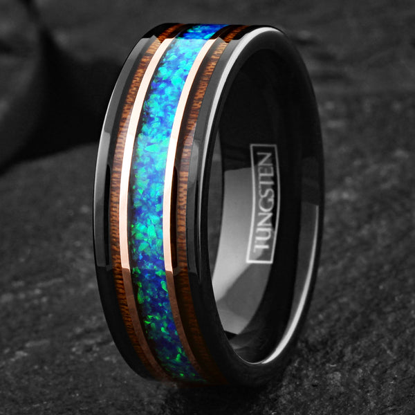 Beautiful Polished Black Tungsten Flat Band Ring with Iridescent Man-Made Crushed Hawaii Blue Opal Inlay Between Two Rose Bands Surrounded By Koa Wood Inlays.