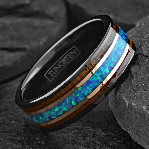 Beautiful Polished Black Tungsten Flat Band Ring with Iridescent Man-Made Crushed Hawaii Blue Opal Inlay Between Two Rose Bands Surrounded By Koa Wood Inlays.