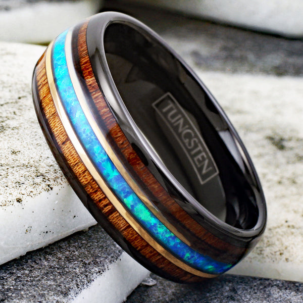 Gorgeous Polished Black Tungsten Low Dome Band Ring with Iridescent Man-Made Crushed Hawaii Blue Opal Inlay Between Two Rose Bands Surrounded By Koa Wood Inlays.