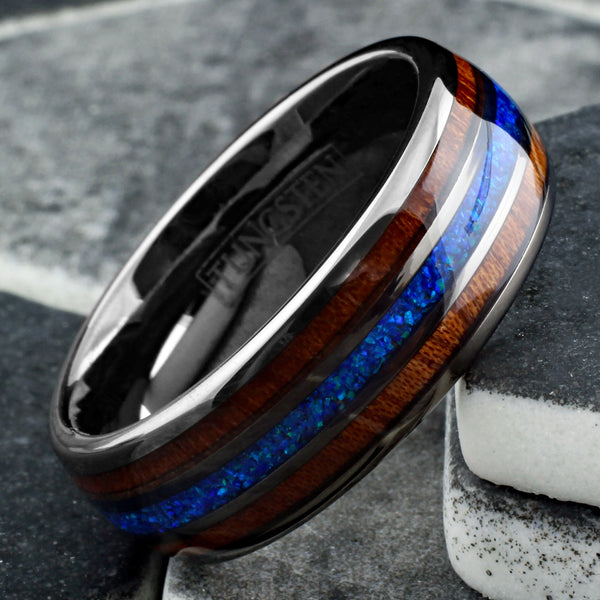 Stunning Polished Gunmetal Gray Tungsten Low Dome Ring with Iridescent Man-Made Crushed Hawaii Blue Opal Inlay Between Two Koa Wood Inlays.