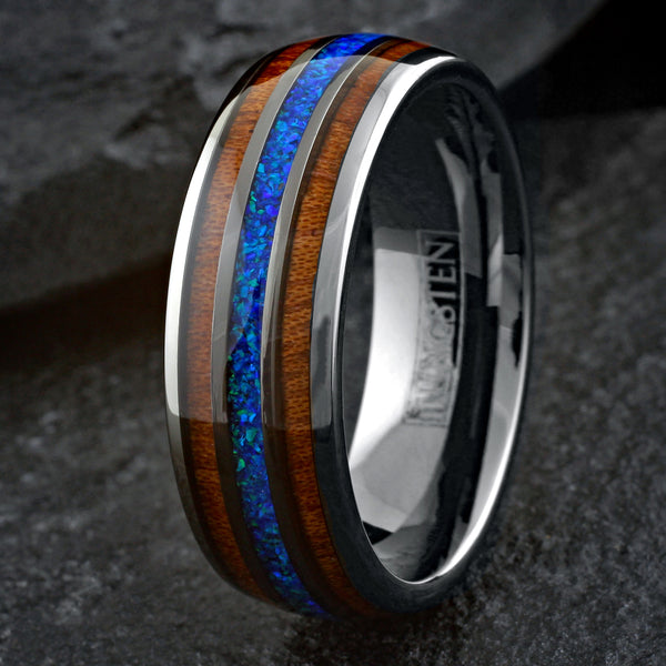Stunning Polished Gunmetal Gray Tungsten Low Dome Ring with Iridescent Man-Made Crushed Hawaii Blue Opal Inlay Between Two Koa Wood Inlays.