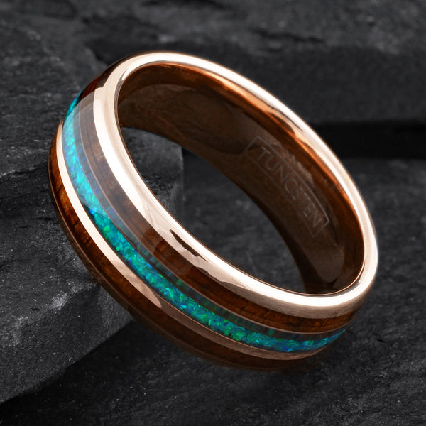 Dazzling Polished Rose Gold Tungsten Low Dome Band Ring with Iridescent Man-Made Crushed Hawaii Blue Opal Inlay Between Two Koa Wood Inlays.