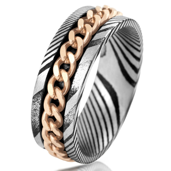 Antiqued black & silver Damascus Steel band ring w/ rose gold Cuban chain inlay | White tilted photo