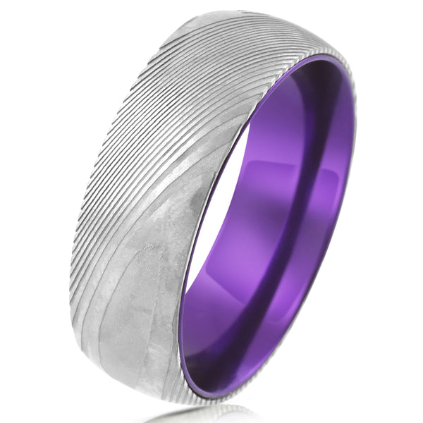 Damascus steel band ring w/ aubergine purple anodized aluminum inner band sleeve | Tilted photo