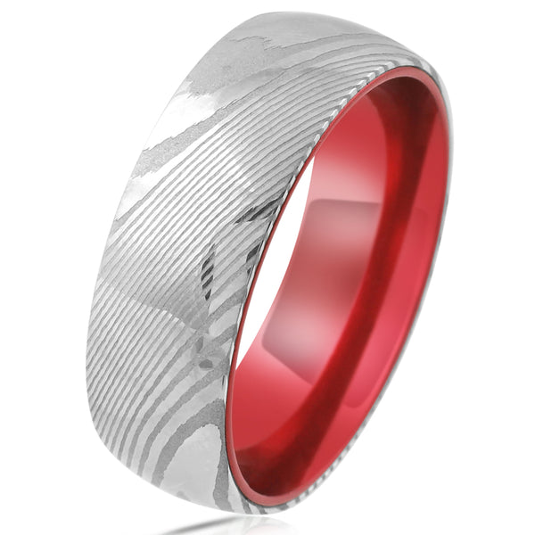 Damascus steel band ring w/ ruby red anodized aluminum inner band sleeve | Tilted photo