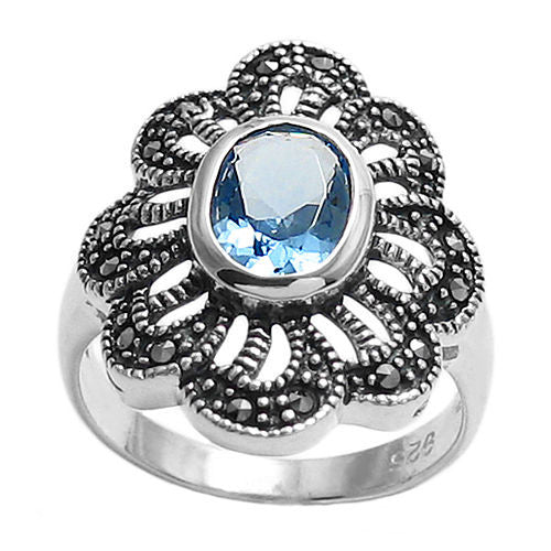 Marcasite flower ring with light blue CZ. Wholesale sterling silver rings. Top view photo.