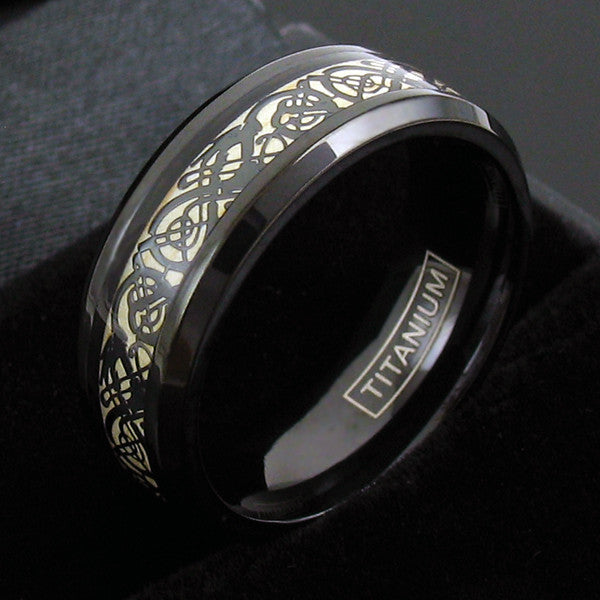 Black titanium ring with black celtic dragon and cappuccino colored inlay | Wholesale Jewelry | Black background photo