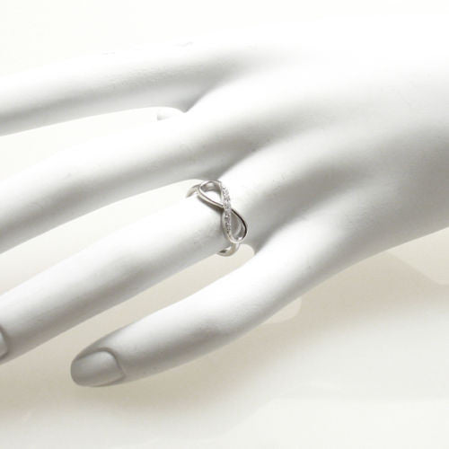 Graceful rhodium finished infinity ring with CZ sparkle | Wholesale sterling silver rings - Jewelry | Hand photo