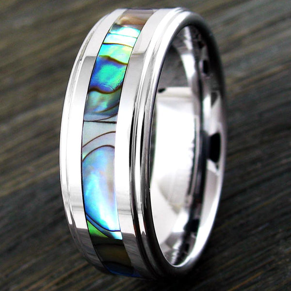 Silver tungsten carbide ring w/ abalone inlay & stepped edges | wholesale tungsten rings - wedding bands | dark wood photo