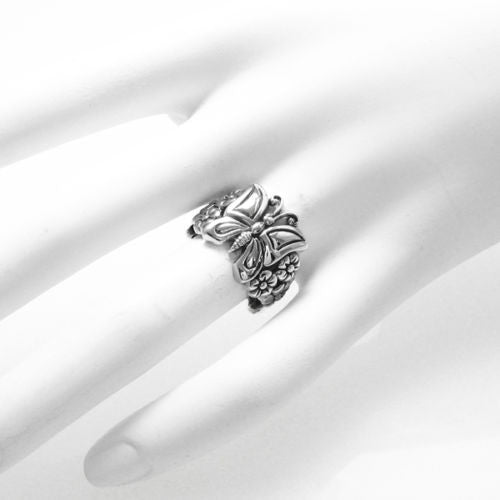 Adorable butterfly sitting on a flower bed waiting to fly away. Wholesale Sterling Silver Rings. On hand.
