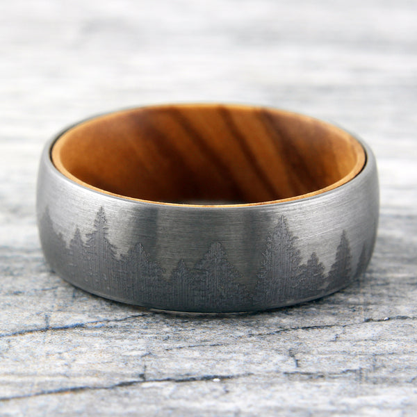 Brushed Finish tungsten carbide band ring w/ etched forest scene & olive wood inner band | Wholesale wedding bands | Marble flat photo